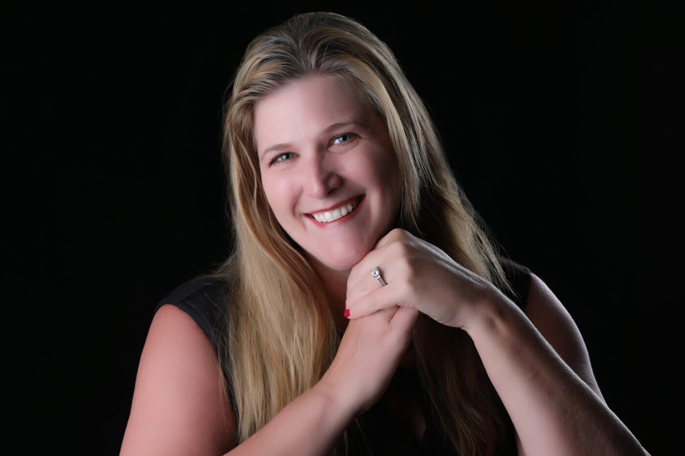 Tisha Templeton, Founder and Principal of AIM Smart Strategies, photographed against a black background.